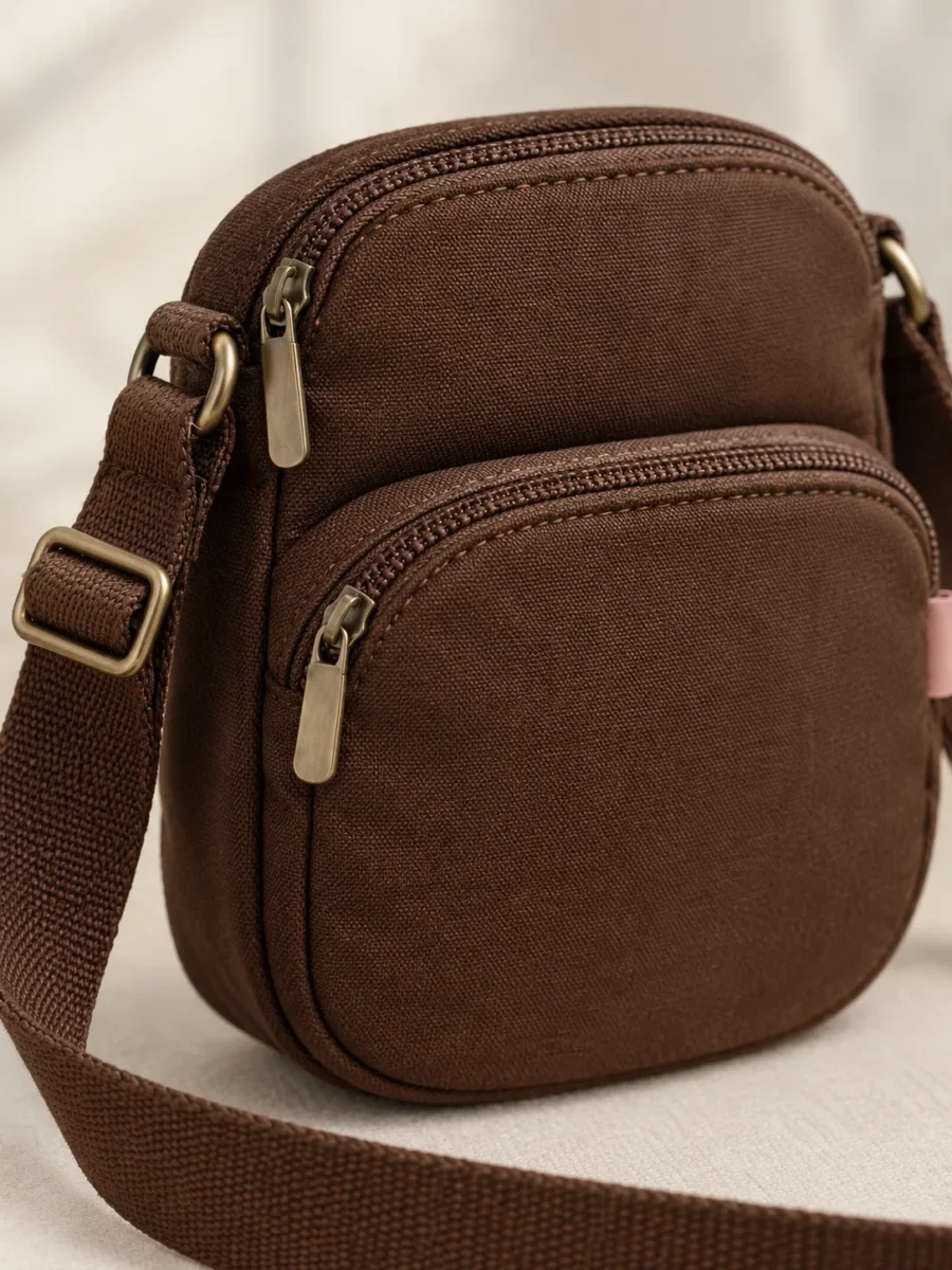 Double Deck Sling in Cocoa, close-up of pockets and hardware