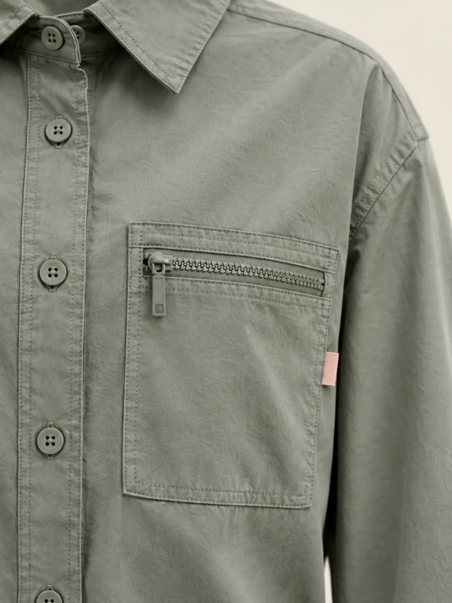 Drawcord Hem Shirt in Sage, close-up of pockets and hardware